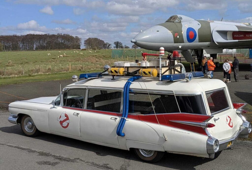 Driver side view of Ecto-1 with the Vulcan in the background.